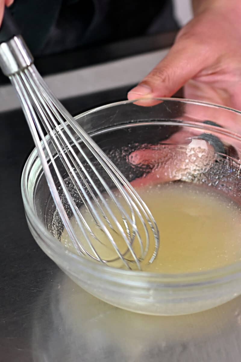 A small bowl is filled with coconut water and powdered gelatin.
