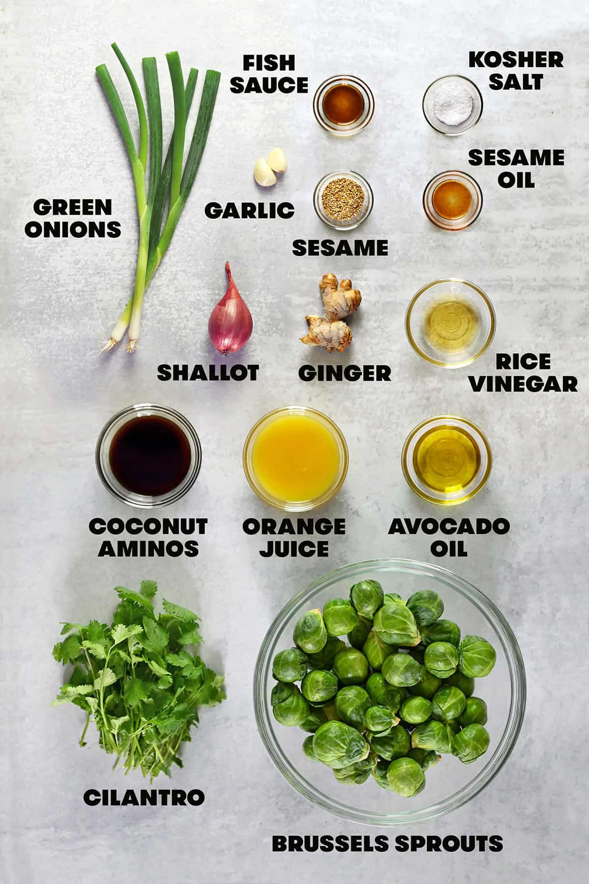 An overhead shot of the raw ingredients to make roasted Brussels sprouts salad with Asian citrus dressing.