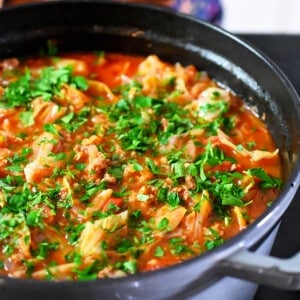 A side view of a gray stockpot filled with paleo and Whole30 cabbage roll soup.