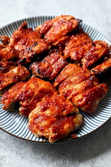 A plate of Char Siu chicken that is sliced up and ready to serve.
