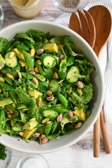 An overhead shot of a big white bowl filled with a vegan and Whole30 chopped salad with sesame ginger dressing.
