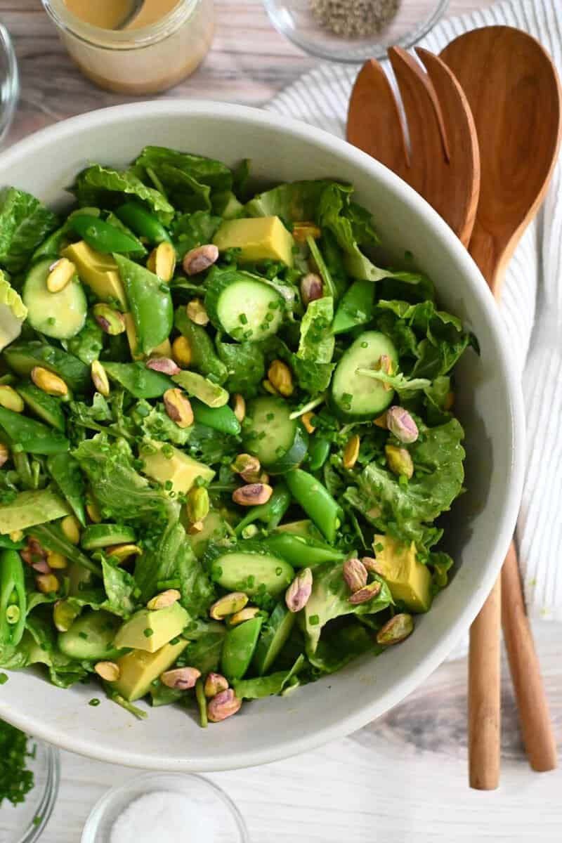 An overhead shot of a big white bowl filled with a vegan and Whole30 chopped salad with sesame ginger dressing.