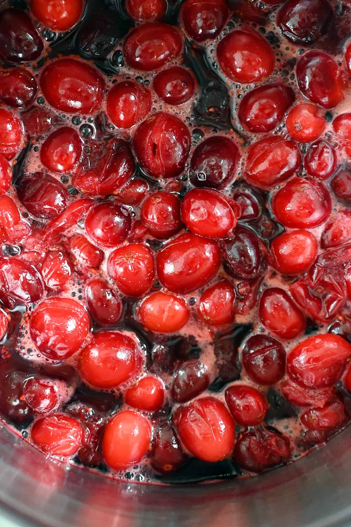 An overhead view of paleo cranberry sauce simmering in a saucepan.