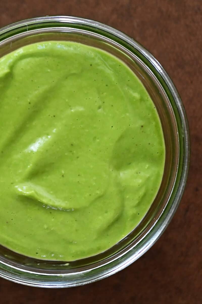 An overhead shot of a jar of Whole30 and vegan Green Goddess Dressing.