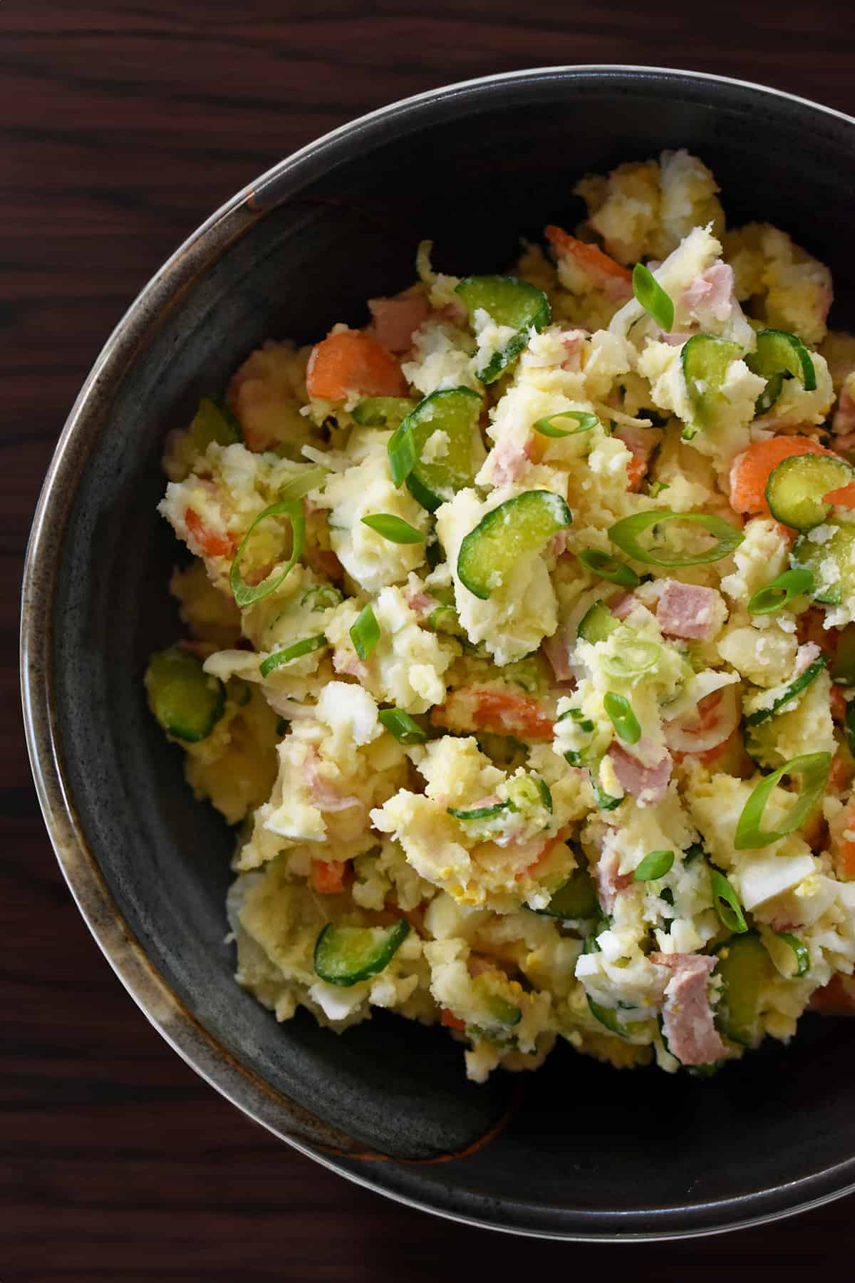 An overhead shot of a serving bowl filled with Japanese potato salad.
