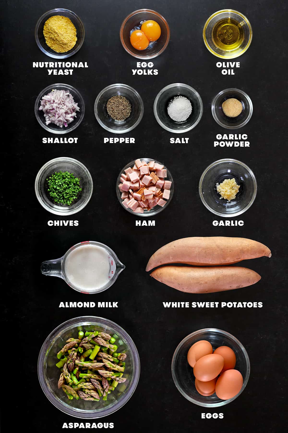 An overhead shot of the raw ingredients to make a paleo asparagus quiche.