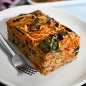 A slice of paleo and Whole30 sausage breakfast casserole on a white plate.