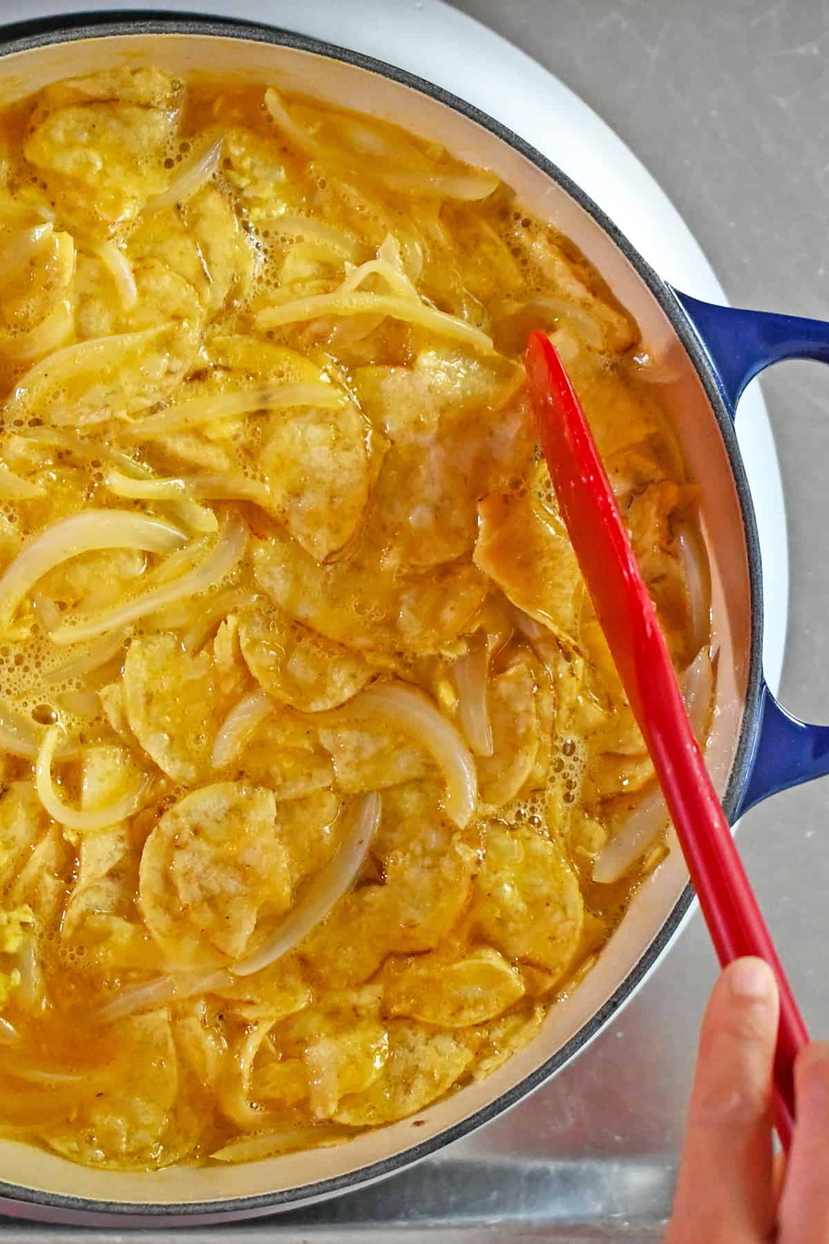 The top of a Spanish tortilla made with potato chips before it is placed under a broiler to finish cooking the top.