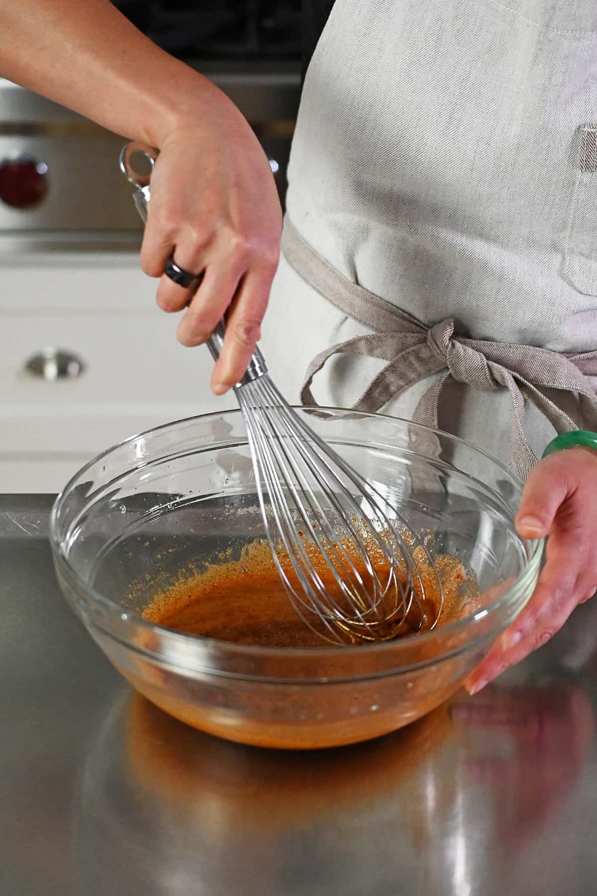 Whisking together frothy whipped raw egg whites and a paleo spice blend.