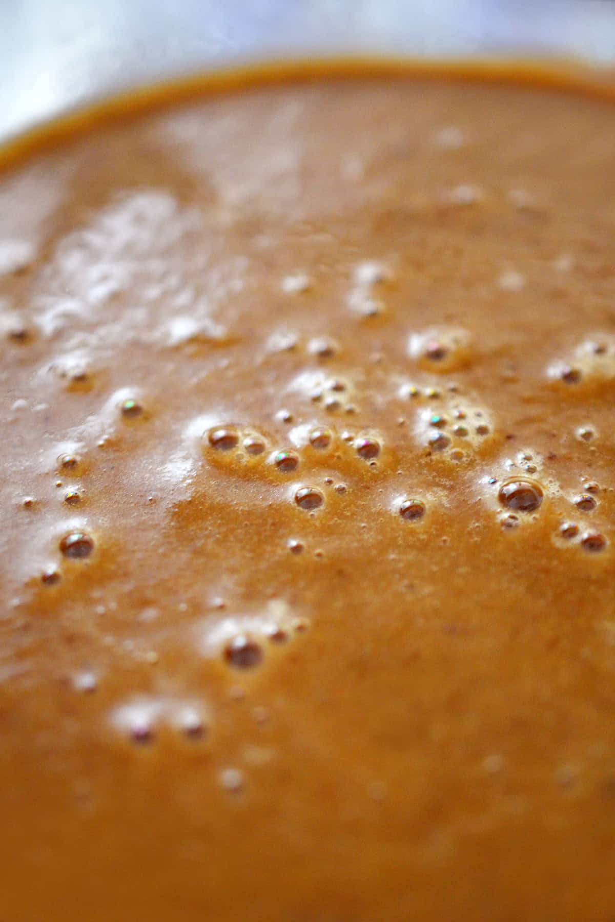 A closeup of a bowl of smooth gluten free gravy.