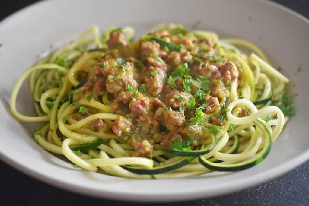A closeup of a plate of Instant Pot Zucchini Bolognese on a bed of zoodles. 