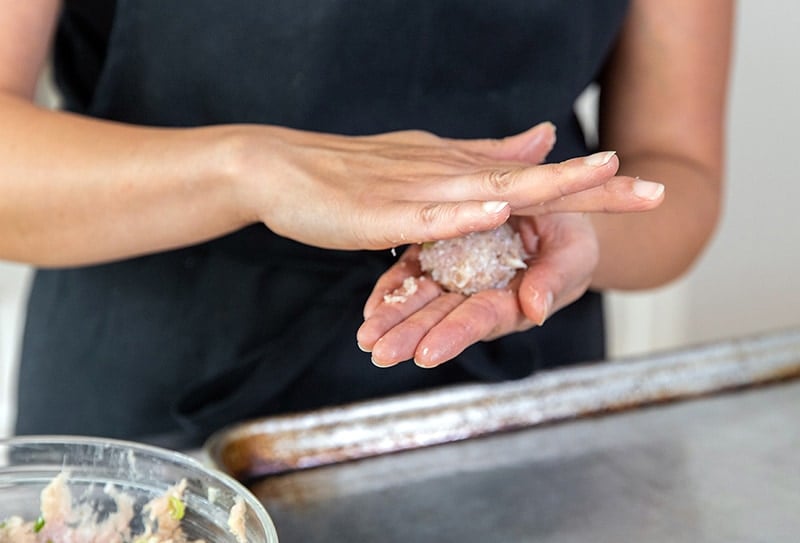 Rolling the tsukune meatballs by hand.