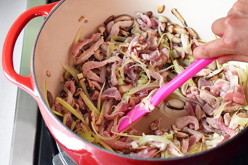 Stir-frying the pork and vegetables for Hot and Sour Soup