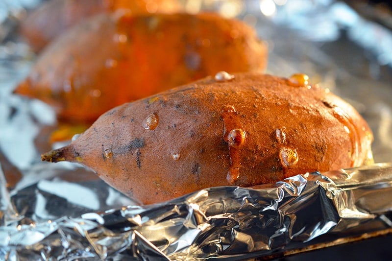 Close-up of baked sweet potatoes right out the oven.