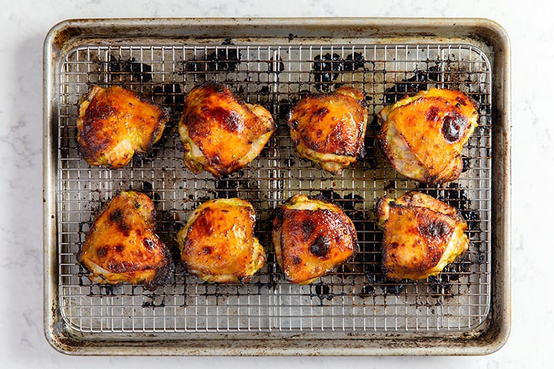 An overhead shot of the gluten-free Asian Chicken thighs out of the oven with golden brown skin.
