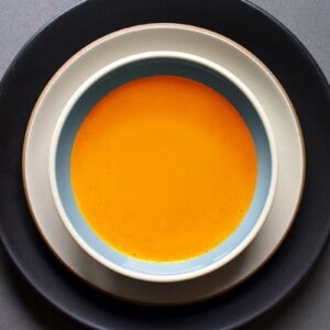 An overhead shot of Carrot Cardamom soup in a serving bowl.
