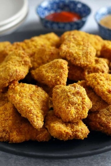 A closeup of a plate topped with air fryer chicken nuggets, a paleo, nut-free, gluten-free, and grain-free favorite.