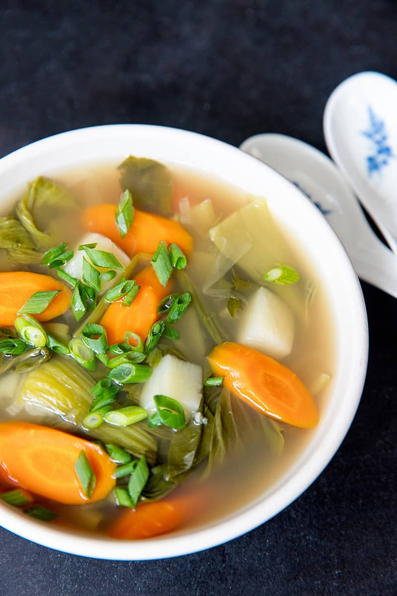 A side view of Instant Pot Vegetable Soup in a white bowl.