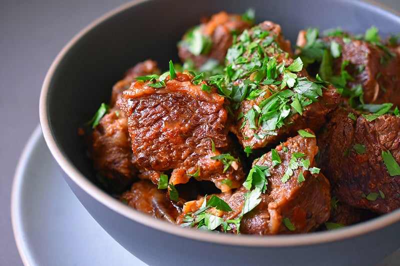 A side view closeup of a bowl of Instant Pot Magic Short Ribs