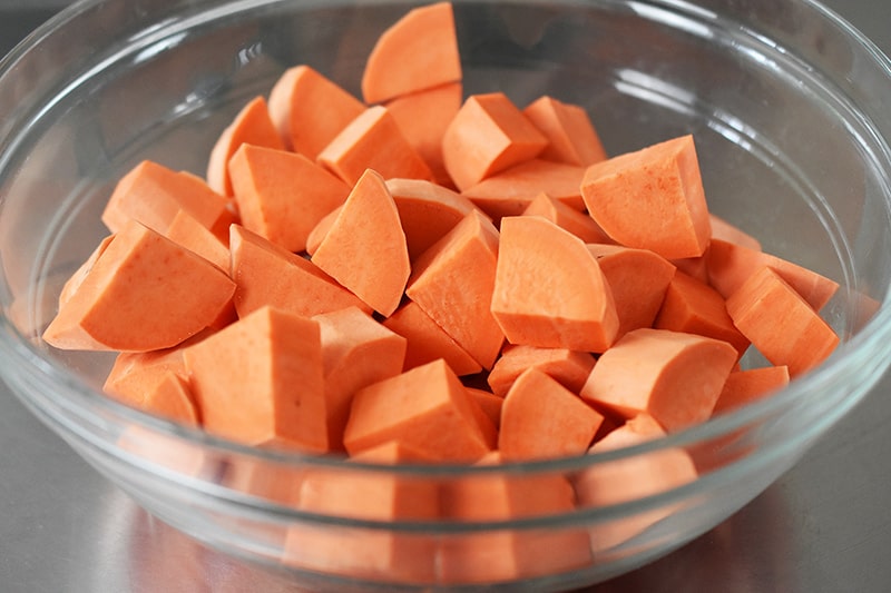 A bowl of sweet potatoes cut into cubes