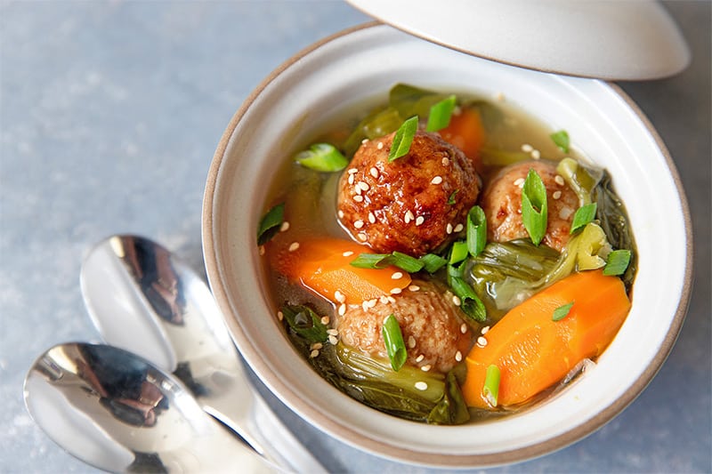 A bowl filled with Instant Pot Vegetable soup and meatballs.