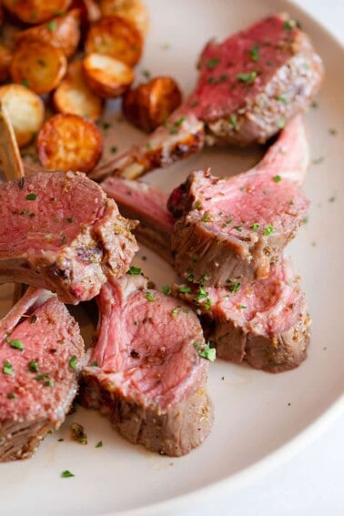 An overhead shot of perfectly cooked lamb chops from two reverse seared racks of lamb.