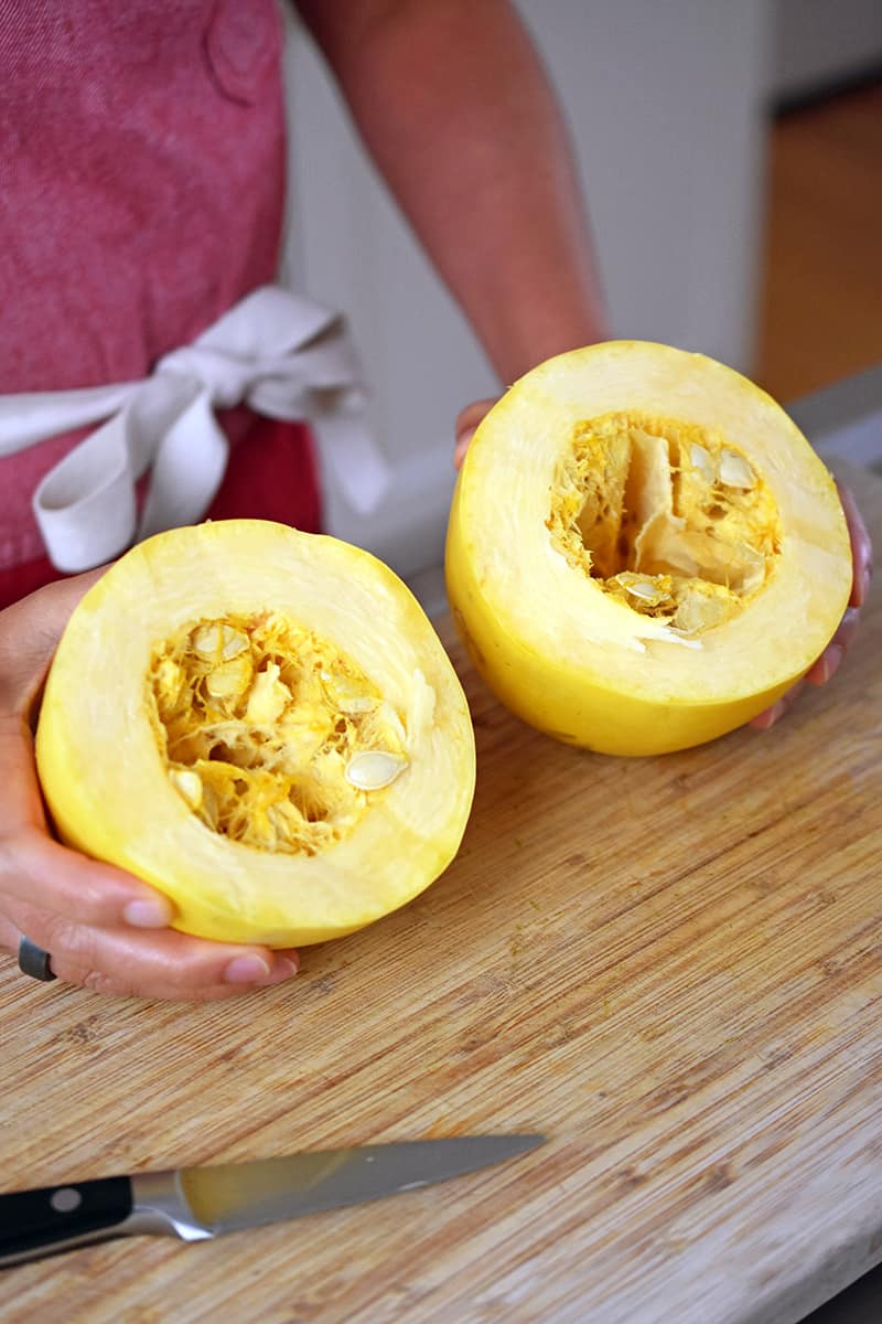 A spaghetti squash cut in half crosswise with the seeds exposed.