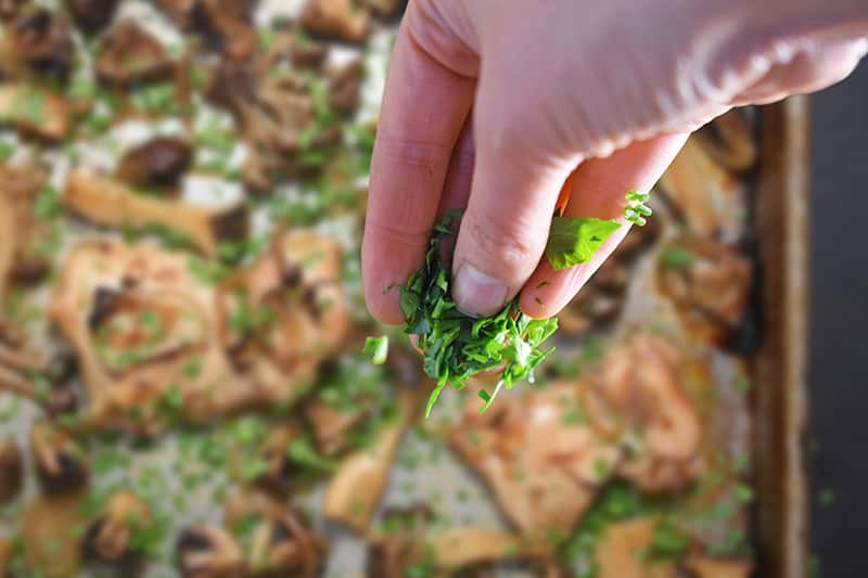 Fresh green herbs are sprinkled on the Sheet Pan Chicken and Mushrooms dinner.
