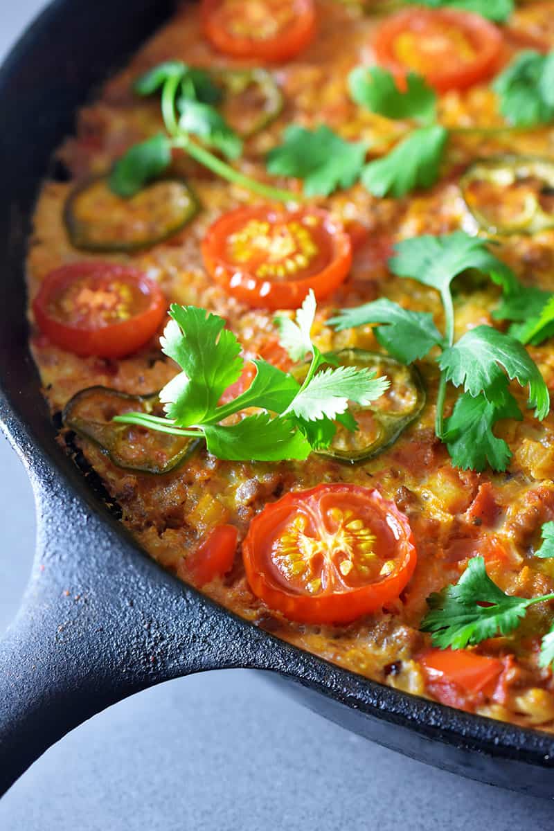 A closeup shot of Tex-Mex Beef and Rice Casserole, a Whole30-friendly one pan meal that you can make in a cast iron skillet.