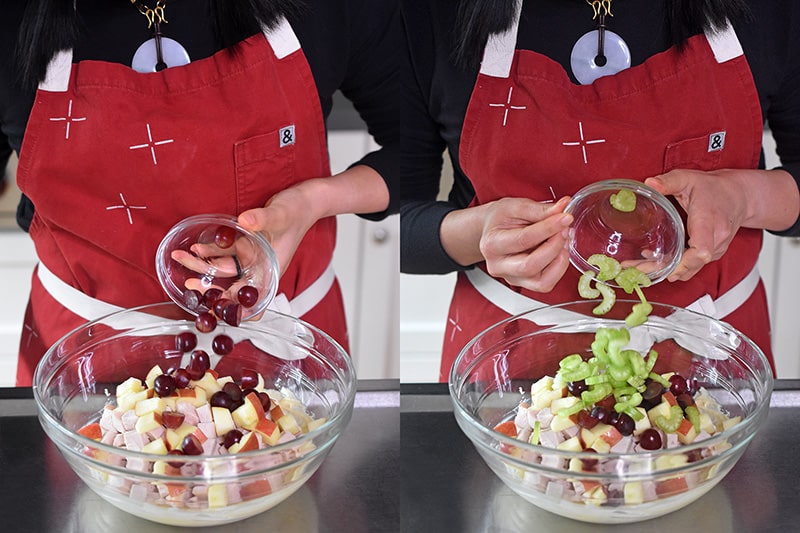 Adding red grapes and celery to a bowl of chicken to make waldorf salad.
