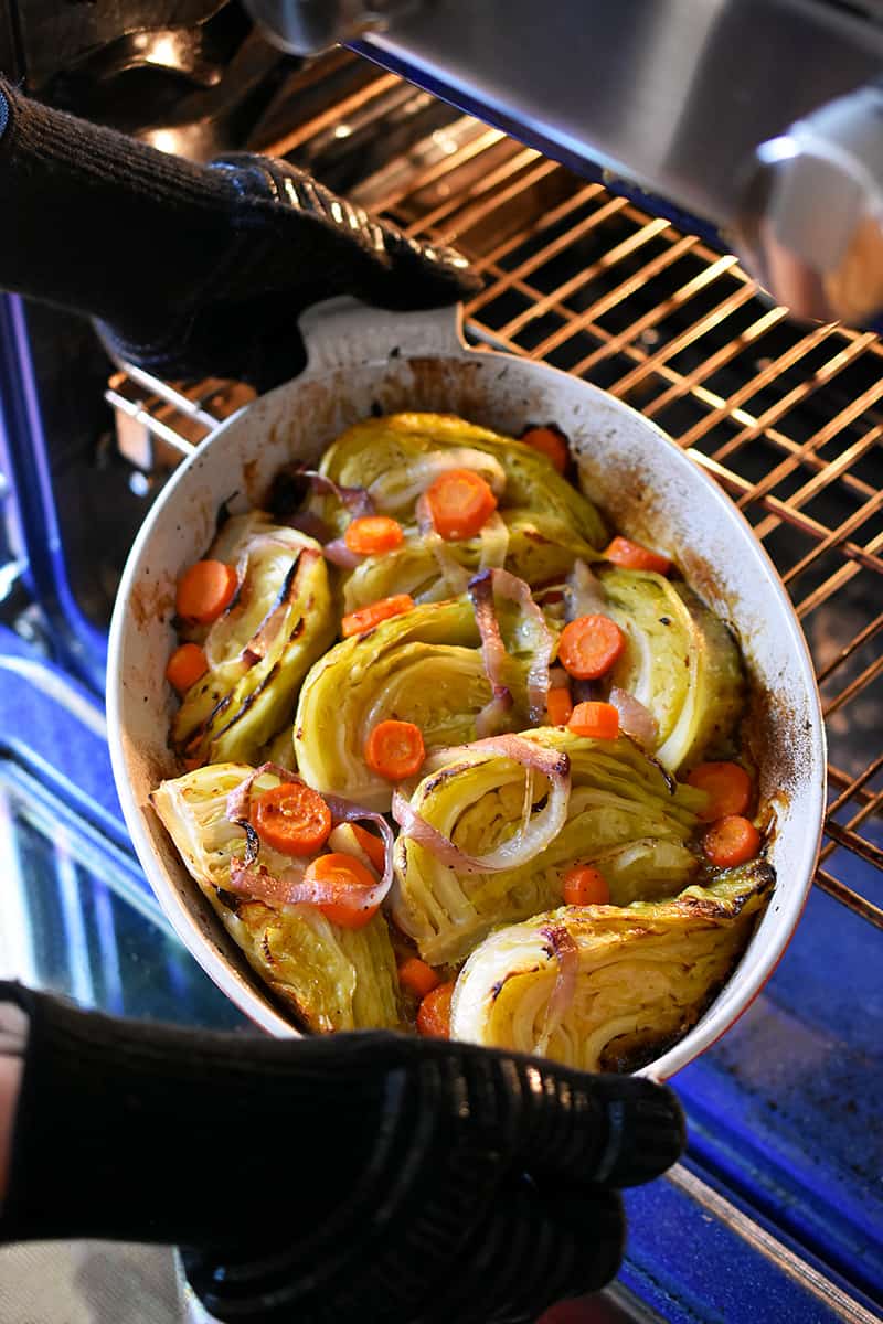 Removing braised cabbage from the oven to serve.