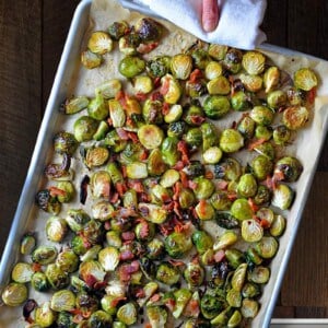 An overhead shot of a rimmed baking sheet filled with Roasted Brussels sprouts with Bacon.