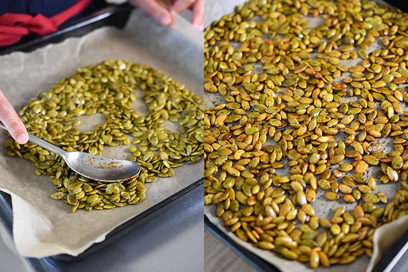 Someone spreading the pepitas in a single layer on a lined baking sheet.