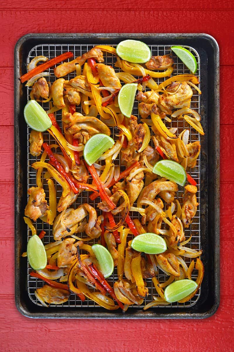 An overhead shot of Sheet Pan Chicken Fajitas + Avocado Crema