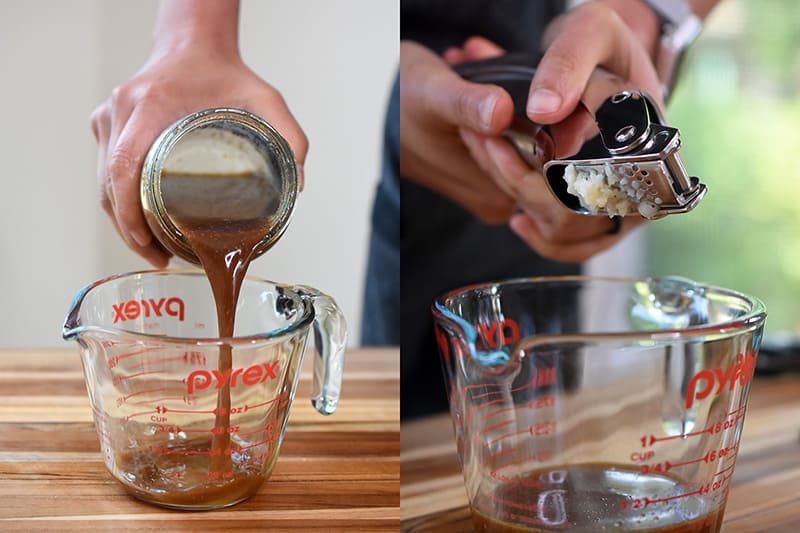 Pouring all-purpose stir fry sauce and smashed garlic into a measuring cup to make the paleo and whole30 dressing.