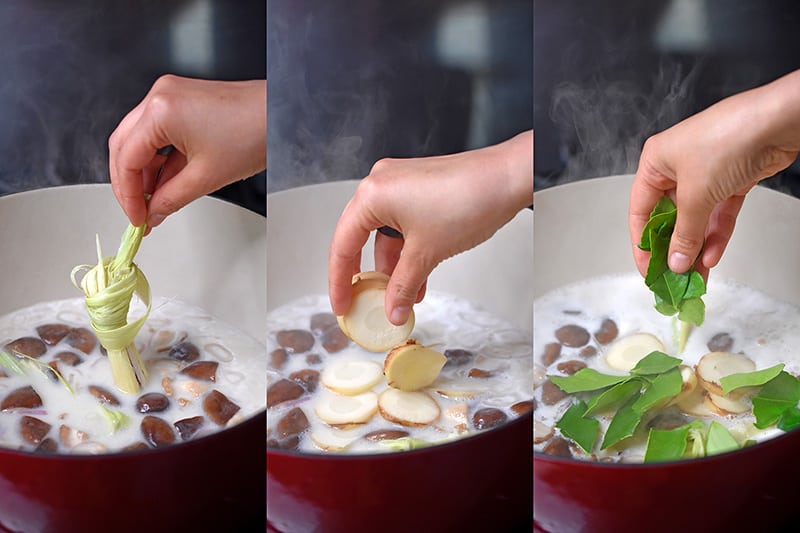 Adding the lemongrass stalk, galangal coins, and Makrut lime leaves to the Whole30 Tom Kha Gai broth