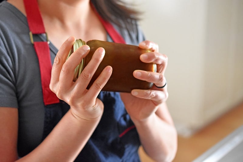 Shaking a jar filled with All-Purpose Stir-Fry Sauce 