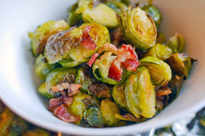 A white bowl filled with Roasted Brussels Sprouts and Bacon 