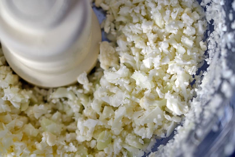 Cauliflower florets pulsed into cauliflower rice in a food processor.