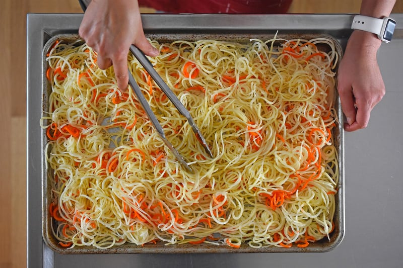 An overhead shot of the swoodles in a rimmed baking sheet, ready to go in the oven.