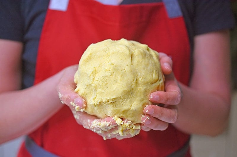 Holding a ball of Paleo Curried Meat Pie dough