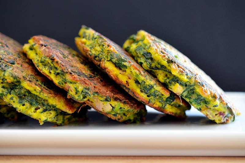 Four paleo egg foo young patties on a white plate.