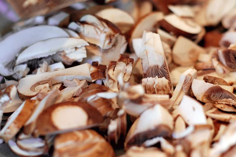A closeup of thinly sliced mushrooms.