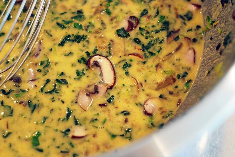 A closeup of Prosciutto-Wrapped Mini Frittata Egg Muffins filling in a large bowl.