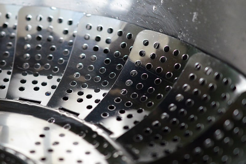 A closeup of a stainless steel steamer in a pot.