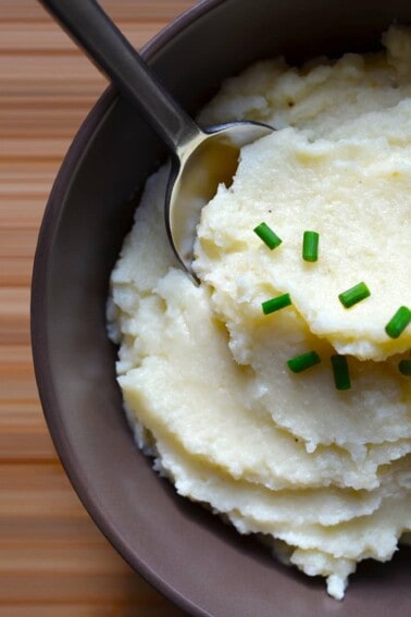 An overhead shot of a bowl filled with garlic caulflower mashed potatoes.