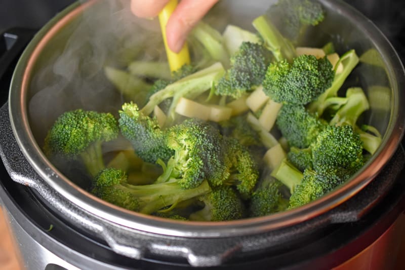 Stirring the contents of Instant Pot Curried Cream of Broccoli Soup before cooking it under high pressure.