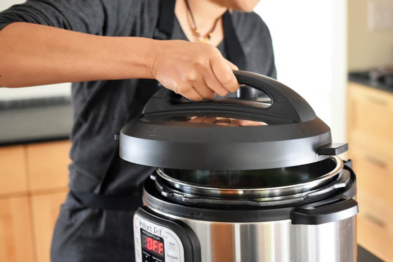 Someone is shown locking the lid on an Instant Pot.