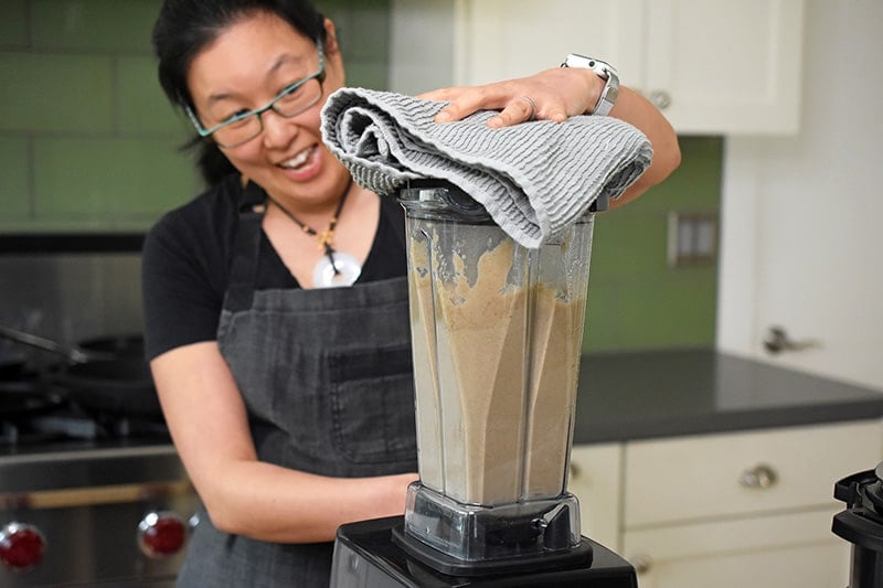 Blending the Instant Pot Cream of Mushroom Soup ingredients in a high speed blender.