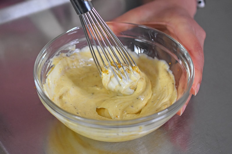 Someone whisking the curried mayo.